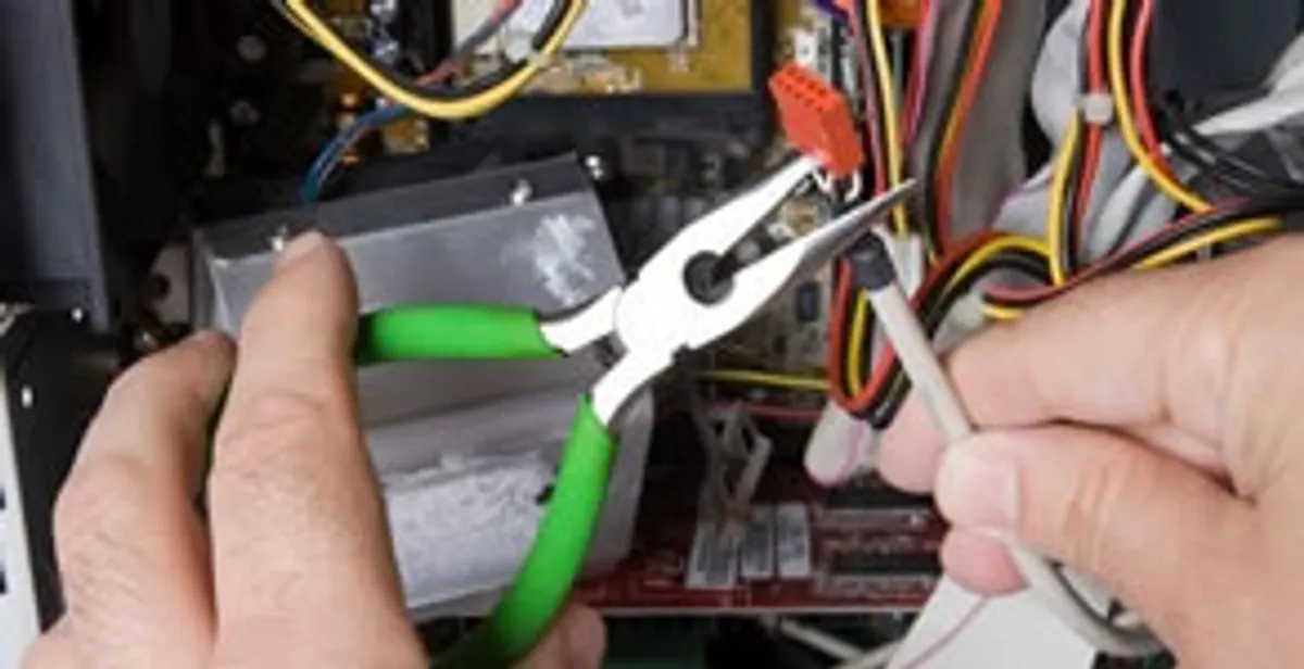 Licensed electrical contractor performing electrical repair with tools in Youngtown, AZ